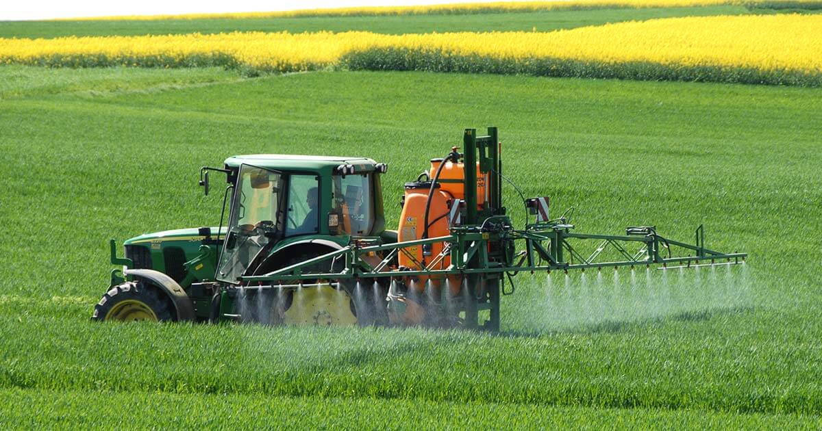 Farmer spraying toxic glyphosate on crops